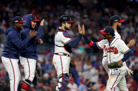 ATLANTA, GEORGIA - OCTOBER 12: Travis d'Arnaud #16 and Ronald Acuna Jr. #13 of the Atlanta Braves high five after defeating the Philadelphia Phillies in game two of the National League Division Series at Truist Park on October 12, 2022 in Atlanta, Georgia. (Photo by Kevin C. Cox/Getty Images)