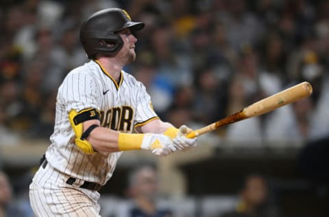 Aug 9, 2022; San Diego, California, USA; San Diego Padres second baseman Jake Cronenworth (9) hits a sacrifice fly during the sixth inning against the San Francisco Giants at Petco Park. Mandatory Credit: Orlando Ramirez-USA TODAY Sports