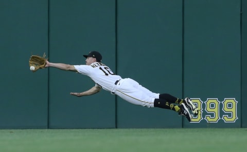 Jun 8, 2021; Pittsburgh, Pennsylvania, USA; Pittsburgh Pirates center fielder Bryan Reynolds (10) dives for but can not catch a ball hit for an RBI double by Los Angeles Dodgers left fielder AJ Pollock (not pictured) during the fifth inning at PNC Park. Mandatory Credit: Charles LeClaire-USA TODAY Sports