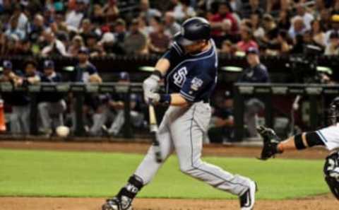 Sep 30, 2016; Phoenix, AZ, USA; San Diego Padres second baseman Ryan Schimpf (11) hits a two run home run in the fourth inning against the Arizona Diamondbacks at Chase Field. Mandatory Credit: Matt Kartozian-USA TODAY Sports