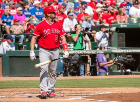 Oct 4, 2015; Arlington, TX, USA; Los Angeles Angels designated hitter Albert Pujols (5) watches his two run home run clear the fences against the Texas Rangers during the first inning at Globe Life Park in Arlington. Mandatory Credit: Jerome Miron-USA TODAY Sports