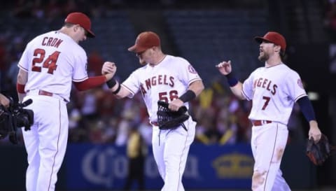 Sep 29, 2015; Anaheim, CA, USA; Los Angeles Angels designated hitter C.J. Cron (24), right fielder Kole Calhoun (56), and left fielder Collin Cowgill (7) celebrate after the game against the Oakland Athletics at Angel Stadium of Anaheim. The Angels defeated the Athletics 8-1. Mandatory Credit: Richard Mackson-USA TODAY Sports