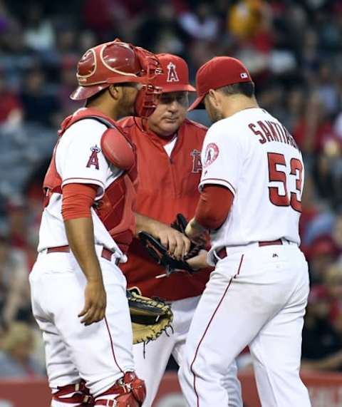 Jun 10, 2016; Anaheim, CA, USA; Los Angeles Angels manager Mike Scioscia (14) relieves starting pitcher Hector Santiago (53) during the second inning against the Cleveland Indians at Angel Stadium of Anaheim. Mandatory Credit: Richard Mackson-USA TODAY Sports