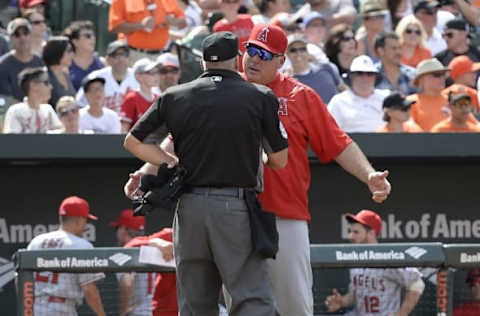 Jul 10, 2016; Baltimore, MD, USA; Los Angeles Angels manager Mike Scioscia (14) speaks with home plate umpire Tim Timmons (95) after he ejected third baseman Yunel Escobar (6) (not pictured) in the seventh inning against the Los Angeles Angels at Oriole Park at Camden Yards. Baltimore Orioles defeated Los Angeles Angels 4-2. Mandatory Credit: Tommy Gilligan-USA TODAY Sports