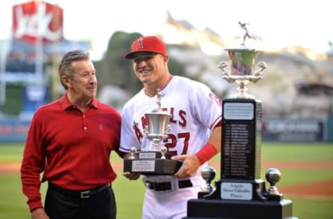 September 20, 2014; Anaheim, CA, USA; Los Angeles Angels center fielder Mike Trout (27) is presented the Angels MVP award by team owner Arte Moreno before playing against the Texas Rangers at Angel Stadium of Anaheim. Mandatory Credit: Gary A.Vasquez-USA TODAY Sports