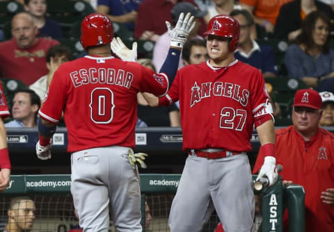 Sep 23, 2016; Houston, TX, USA; Los Angeles Angels third baseman Yunel Escobar (0) celebrates with center fielder Mike Trout (27) after hitting a home run during the ninth inning against the Houston Astros at Minute Maid Park. Mandatory Credit: Troy Taormina-USA TODAY Sports