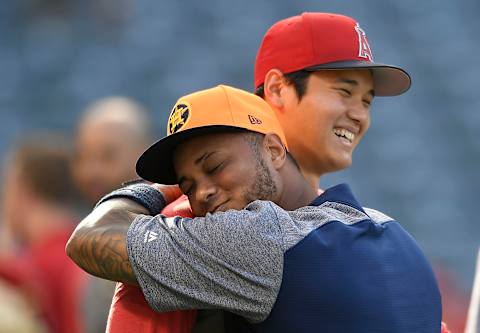 ANAHEIM, CA – APRIL 24: Houston Astros Martín Maldonado hugs Shohei Ohtani #17 of the Los Angeles Angels of Anaheim during batting practice at Angel Stadium on April 24, 2018 in Anaheim, California. All players across MLB will wear nicknames on their backs as well as colorful, non-traditional uniforms featuring alternate designs inspired by youth-league uniforms. (Photo by John McCoy/Getty Images)