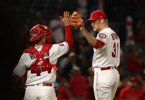 ANAHEIM, CA – SEPTEMBER 11: Catcher Joe Hudson #44 and closing pitcher Ty Buttrey #31 of the Los Angeles Angels of Anaheim celebrate with a high-five after the MLB game at Angel Stadium on September 11, 2018 in Anaheim, California. The Angels defeated the Ranger 1-0. (Photo by Victor Decolongon/Getty Images)