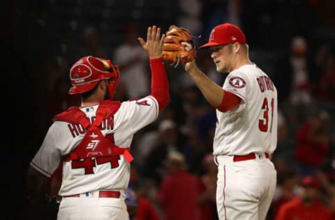 ANAHEIM, CA – SEPTEMBER 11: Catcher Joe Hudson #44 and closing pitcher Ty Buttrey #31 of the Los Angeles Angels of Anaheim celebrate with a high-five after the MLB game at Angel Stadium on September 11, 2018 in Anaheim, California. The Angels defeated the Ranger 1-0. (Photo by Victor Decolongon/Getty Images)