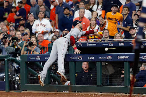 HOUSTON, TX – OCTOBER 17: Steve Pearce #25 of the Boston Red Sox falls into the Houston Astros dugout as he attempts to catch a foul ball hit by Josh Reddick #22 of the Houston Astros (not pictured) in the seventh inning during Game Four of the American League Championship Series at Minute Maid Park on October 17, 2018 in Houston, Texas. (Photo by Bob Levey/Getty Images)