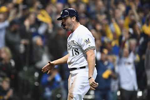 MILWAUKEE, WI – OCTOBER 19: Mike Moustakas #18 of the Milwaukee Brewers celebrates after scoring a run off of a single hit by Erik Kratz #15 against Hyun-Jin Ryu #99 of the Los Angeles Dodgers during the first inning in Game Six of the National League Championship Series at Miller Park on October 19, 2018 in Milwaukee, Wisconsin. (Photo by Stacy Revere/Getty Images)