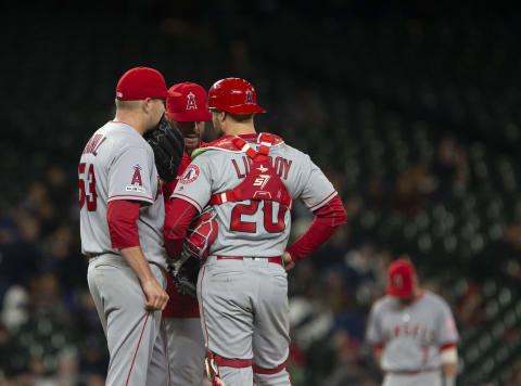 SEATTLE, WA – APRIL 02: Trevor Cahill #53 and Jonathan Lucroy #20 huddle with pitching coach Doug White in the sixth inning against the Seattle Mariners at T-Mobile Park on April 2, 2019 in Seattle, Washington. (Photo by Lindsey Wasson/Getty Images)