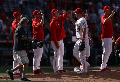 ANAHEIM, CALIFORNIA – APRIL 07: Mike Trout #27 of the Los Angeles Angels of Anaheim gets a high-five from teammate Shohei Ohtani after their MLB game against the Texas Rangers at Angel Stadium of Anaheim on April 07, 2019 in Anaheim, California. The Angels defeated the Rangers 7-2. (Photo by Victor Decolongon/Getty Images)