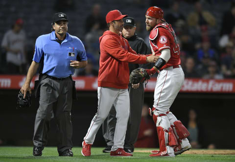 ANAHEIM, CA – APRIL 10: Manager Brad Ausmus of the Los Angeles Angels of Anaheim holds back his catcher Kevan Smith after he was ejected from the game by home plate umpire Phil Cuzzi in the seventh inning while playing the Milwaukee Brewers at Angel Stadium of Anaheim on April 10, 2019 in Anaheim, California. (Photo by John McCoy/Getty Images)