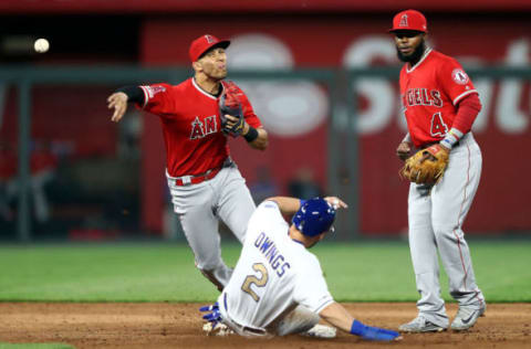 KANSAS CITY, MISSOURI – APRIL 26: Shortstop Andrelton Simmons #2 of the Los Angeles Angels throws toward first for a double play as Chris Owings #2 of the Kansas City Royals slides into second during the game at Kauffman Stadium on April 26, 2019 in Kansas City, Missouri. (Photo by Jamie Squire/Getty Images)