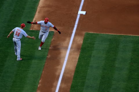 ANAHEIM, CALIFORNIA – JUNE 26: J.R. House #56 congratulates Yasiel Puig #66 of the Cincinnati Reds after his solo homerun during the fifth inning of a game against the Los Angeles Angels of Anaheim at Angel Stadium of Anaheim on June 26, 2019 in Anaheim, California. (Photo by Sean M. Haffey/Getty Images)