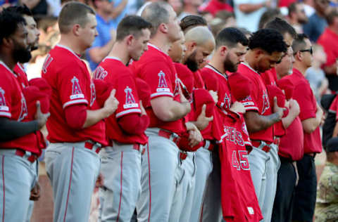 ARLINGTON, TEXAS – JULY 02: Members of the Los Angeles Angels hold the jersey of Tyler Skaggs #45 of the Los Angeles Angels during a moment of silence before taking on the Texas Rangers at Globe Life Park in Arlington on July 02, 2019 in Arlington, Texas. (Photo by Tom Pennington/Getty Images)