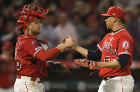 ANAHEIM, CA – AUGUST 15: Max Stassi #33 of the Los Angeles Angels congratulates Hansel Robles #57 after he struck out Ryan Goins #17 of the Chicago White Sox for the final out in the ninth inning at Angel Stadium of Anaheim on August 15, 2019 in Anaheim, California. Angles went on to win 8-7. (Photo by John McCoy/Getty Images)