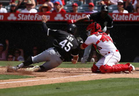 ANAHEIM, CALIFORNIA – AUGUST 18: Catcher Anthony Bemboom #48 of the Los Angeles Angels puts the tag on Jon Jay #45 of the Chicago White Sox at home plate for the third out in the sixth inning of the MLB game at Angel Stadium of Anaheim on August 18, 2019 in Anaheim, California. The Angels defeated the White Sox 9-2. (Photo by Victor Decolongon/Getty Images)