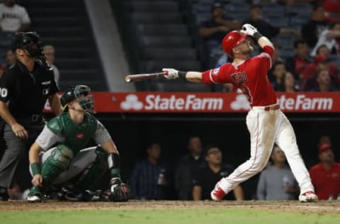 ANAHEIM, CALIFORNIA – SEPTEMBER 25: Taylor Ward #3 of the Los Angeles Angels of Anaheim flies out as Josh Phegley #19 of the Oakland Athletics looks on during the seventh inning of a game against the Oakland Athletics at Angel Stadium of Anaheim on September 25, 2019 in Anaheim, California. (Photo by Sean M. Haffey/Getty Images)