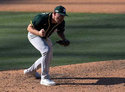 LOS ANGELES, CALIFORNIA – OCTOBER 07: Liam Hendriks #16 of the Oakland Athletics reacts to striking out Josh Reddick #22 of the Houston Astros to end the eighth inning in Game Three of the American League Division Series at Dodger Stadium on October 07, 2020 in Los Angeles, California. (Photo by Harry How/Getty Images)