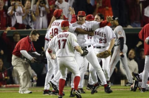 ANAHEIM, CA – OCTOBER 27: Rightfielder Tim Salmon #15, centerfielder Darin Erstad #17 and rightfielder Alex Ochoa #18 of the Anaheim Angels celebrate winning game seven of the World Series over the San Francisco Giants on October 27, 2002 at Edison Field in Anaheim, California. The Angels defeated the Giants 4-1 to claim their first World Series Championship. (Photo by Jeff Gross/Getty Images)