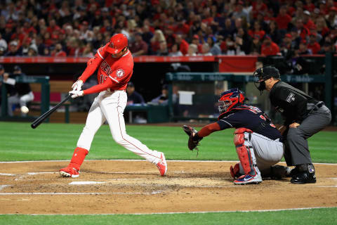 ANAHEIM, CA – APRIL 03: Shohei Ohtani #17 of the Los Angeles Angels of Anaheim hits a three-run homerun during the first inning of a game as Roberto Perez #55 of the Cleveland Indians and umpire Jim Reynolds look on at Angel Stadium on April 3, 2018 in Anaheim, California. (Photo by Sean M. Haffey/Getty Images)