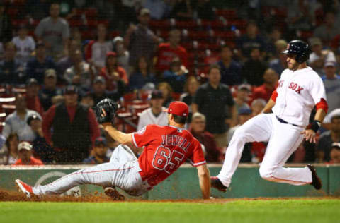 BOSTON, MA – JUNE 27: J.D. Martinez #28 of the Boston Red Sox slides safely into home plate as Jake Jewell #65 of the Los Angeles Angels injures his right ankle as he slides into home plate in an attempt to tag out Martinez in the eighth inning of a game at Fenway Park on June 27, 2018 in Boston, Massachusetts. (Photo by Adam Glanzman/Getty Images)