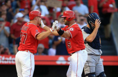 ANAHEIM, CA – JULY 12: Mike Trout #27 congratulates Albert Pujols #5 of the Los Angeles Angels of Anaheim after his two-run homerun while David Freitas #36 of the Seattle Mariners looks on during the first inning of a game at Angel Stadium on July 12, 2018 in Anaheim, California. (Photo by Sean M. Haffey/Getty Images)