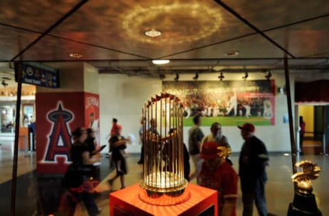 ANAHEIM, CA – APRIL 06: Fans look at the 2002 World Series trophy of Los Angeles Angels at Angels Stadium of Anaheim after the gates opened for the Los Angeles Angels home opener against the Oakland Athletics on opening day April 6, 2009 in Anaheim, California. (Photo by Kevork Djansezian/Getty Images)