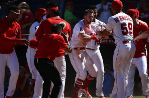 ANAHEIM, CA – SEPTEMBER 30: Taylor Ward #3 of the Los Angeles Angels of Anaheim is mobbed by his teammates after hitting a walk-off home run during the ninth inning of the the MLB game against the Oakland Athletics at Angel Stadium on September 30, 2018 in Anaheim, California. The Angels defeated the Athletics 5-4. (Photo by Victor Decolongon/Getty Images)