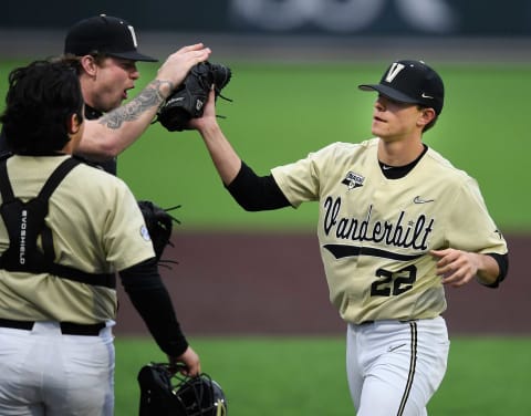 Vanderbilt pitcher Tyler Brown and catcher CJ Rodriguez, left, congratulate freshman pitcher Jack Leiter (22) after he strike out all three South Alabama batters during the first inning at Hawkins Field Feb. 18, 2020.Nas Vandy Baseball Home Opener 019