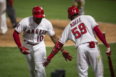 Sep 16, 2020; Anaheim, California, USA; Los Angeles Angels left fielder Justin Upton (10) is congratulated by right fielder Jo Adell (59) for scoring against the Arizona Diamondbacks during the game at Angel Stadium. Mandatory Credit: Angels Baseball/Pool Photo via USA TODAY Network