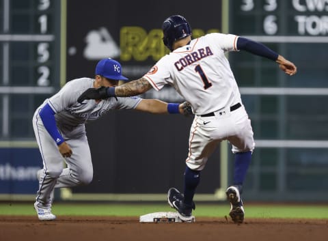 Aug 23, 2021; Houston, Texas, USA; Houston Astros shortstop Carlos Correa (1) is tagged out by Kansas City Royals second baseman Whit Merrifield (15) during the fourth inning at Minute Maid Park. Mandatory Credit: Troy Taormina-USA TODAY Sports