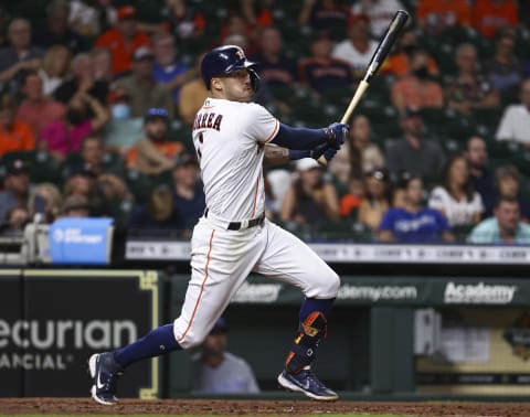 Aug 23, 2021; Houston, Texas, USA; (Editors Notes: Caption Correction) Houston Astros shortstop Carlos Correa (1) hits a single against the Kansas City Royals during the fourth inning at Minute Maid Park. Mandatory Credit: Troy Taormina-USA TODAY Sports