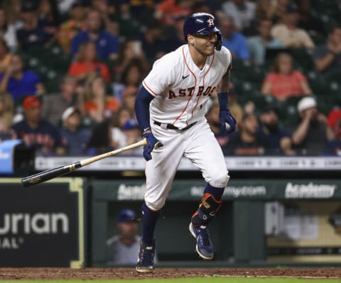 Aug 24, 2021; Houston, Texas, USA; Houston Astros shortstop Carlos Correa (1) hits a single against the Kansas City Royals during the fifth inning at Minute Maid Park. Mandatory Credit: Troy Taormina-USA TODAY Sports