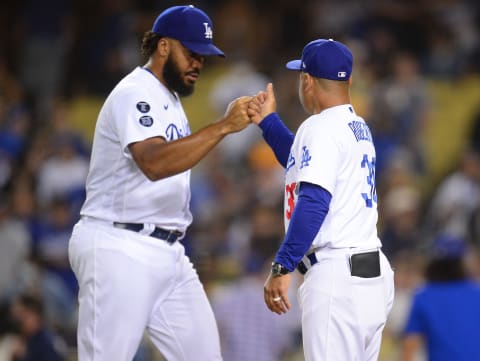 Oct 1, 2021; Los Angeles, California, USA; Los Angeles Dodgers relief pitcher Kenley Jansen (74) and manager Dave Roberts (30) celebrate the 8-6 victory against the Milwaukee Brewers at Dodger Stadium. Mandatory Credit: Gary A. Vasquez-USA TODAY Sports