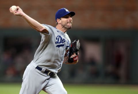 Oct 17, 2021; Cumberland, Georgia, USA; Los Angeles Dodgers starting pitcher Max Scherzer (31) cycles through a pitch during the fifth inning against the Atlanta Braves in game two of the 2021 NLCS at Truist Park. Mandatory Credit: Brett Davis-USA TODAY Sports