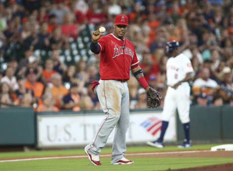 Jun 10, 2017; Houston, TX, USA; Los Angeles Angels third baseman Yunel Escobar (0) is unable to make a play on a bunt single by Houston Astros second baseman Jose Altuve (not pictured) during the first inning at Minute Maid Park. Mandatory Credit: Troy Taormina-USA TODAY Sports