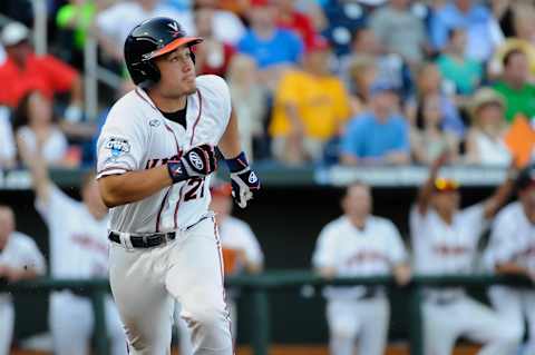 Jun 20, 2015; Omaha, NE, USA; Virginia Cavaliers catcher Matt Thaiss (21) looks at his first inning home run in the first inning against the Florida Gators in the 2015 College World Series at TD Ameritrade Park. Mandatory Credit: Steven Branscombe-USA TODAY Sports