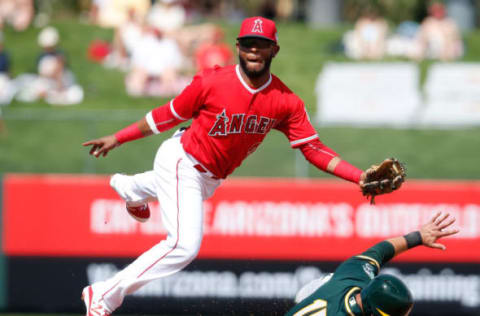 Mar 3, 2016; Tempe, AZ, USA; Los Angeles Angels second baseman Rey Navarro (20) gets the force out while avoiding Oakland Athletics left fielder Andrew Lambo (15) in the second inning during a spring training game at Tempe Diablo Stadium. Mandatory Credit: Rick Scuteri-USA TODAY Sports