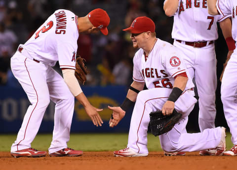 Sep 26, 2016; Anaheim, CA, USA; Los Angeles Angels right fielder Kole Calhoun (56) is met with a low five by shortstop Andrelton Simmons (2) after the game against the Oakland Athletics at Angel Stadium of Anaheim. The Angels won 2-1. Mandatory Credit: Jayne Kamin-Oncea-USA TODAY Sports