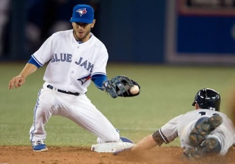 Apr 4, 2014; Toronto, Ontario, CAN; New York Yankees center fielder Brett Gardner (11) steals second base as Toronto Blue Jays shortstop Jonathan Diaz (1) is not able to apply the tag in a game at Rogers Centre. The New York Yankees won 7-3. Mandatory Credit: Nick Turchiaro-USA TODAY Sports