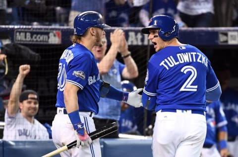 Oct 9, 2016; Toronto, Ontario, CAN; Toronto Blue Jays shortstop Troy Tulowitzki (2) reacts with third baseman 