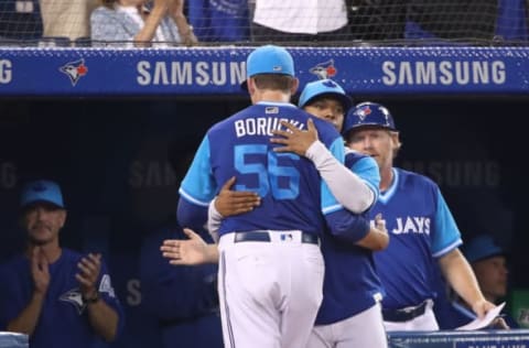 TORONTO, ON – AUGUST 24: Ryan Borucki #56 of the Toronto Blue Jays is congratulated by Marcus Stroman #6 after coming out of the game in the seventh inning during MLB game action against the Philadelphia Phillies at Rogers Centre on August 24, 2018 in Toronto, Canada. The players are wearing special jerseys as part of MLB Players Weekend. (Photo by Tom Szczerbowski/Getty Images)