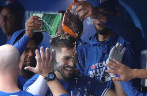 TORONTO, ON – SEPTEMBER 26: Randal Grichuk #15 of the Toronto Blue Jays is congratulated by teammates in the dugout after hitting a two-run home run in the first inning during MLB game action against the Houston Astros at Rogers Centre on September 26, 2018 in Toronto, Canada. (Photo by Tom Szczerbowski/Getty Images)