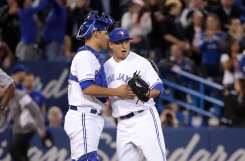 TORONTO, ON – MARCH 29: Javy Guerra #48 of the Toronto Blue Jays celebrates their victory with Luke Maille #21 during MLB game action against the Detroit Tigers at Rogers Centre on March 29, 2019 in Toronto, Canada. (Photo by Tom Szczerbowski/Getty Images)