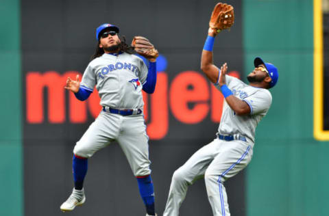 CLEVELAND, OHIO – APRIL 07: Shortstop Freddy Galvis #16 and Socrates Brito #38 of the Toronto Blue Jays as Brito catches a fly ball hit by Kevin Plawecki #27 of the Cleveland Indians during the fourth inning at Progressive Field on April 07, 2019 in Cleveland, Ohio. (Photo by Jason Miller/Getty Images)