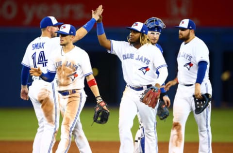 TORONTO, ON – JULY 03: Vladimir Guerrero Jr. #27 (C) of the Toronto Blue Jays celebrates victory with teammates following a MLB game against the Boston Red Sox at Rogers Centre on July 03, 2019 in Toronto, Canada. (Photo by Vaughn Ridley/Getty Images)