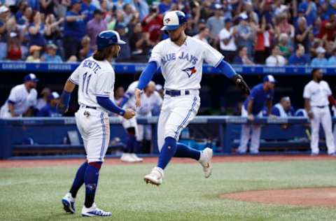 TORONTO, ON – AUGUST 10: Bo Bichette #11 of the Toronto Blue Jays welcomes Cavan Biggio #8 to the plate as they score on Vladimir Guerrero Jr. #27’s triple in the 7th inning during MLB action against the New York Yankees at Rogers Centre on August 10, 2019 in Toronto, Canada. (Photo by Cole Burston/Getty Images)